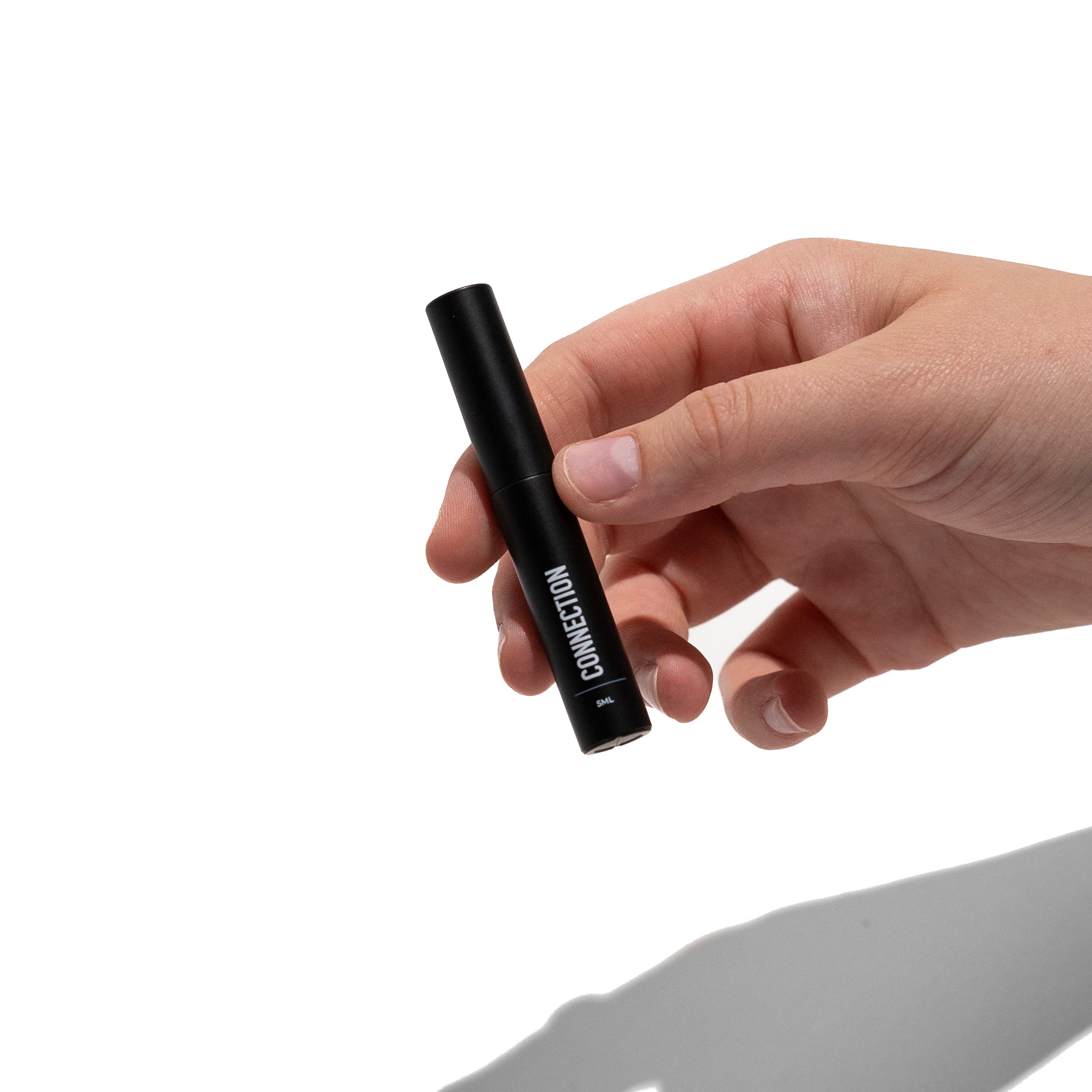 person's hand holding diy lash extension adhesive for temporary lashes