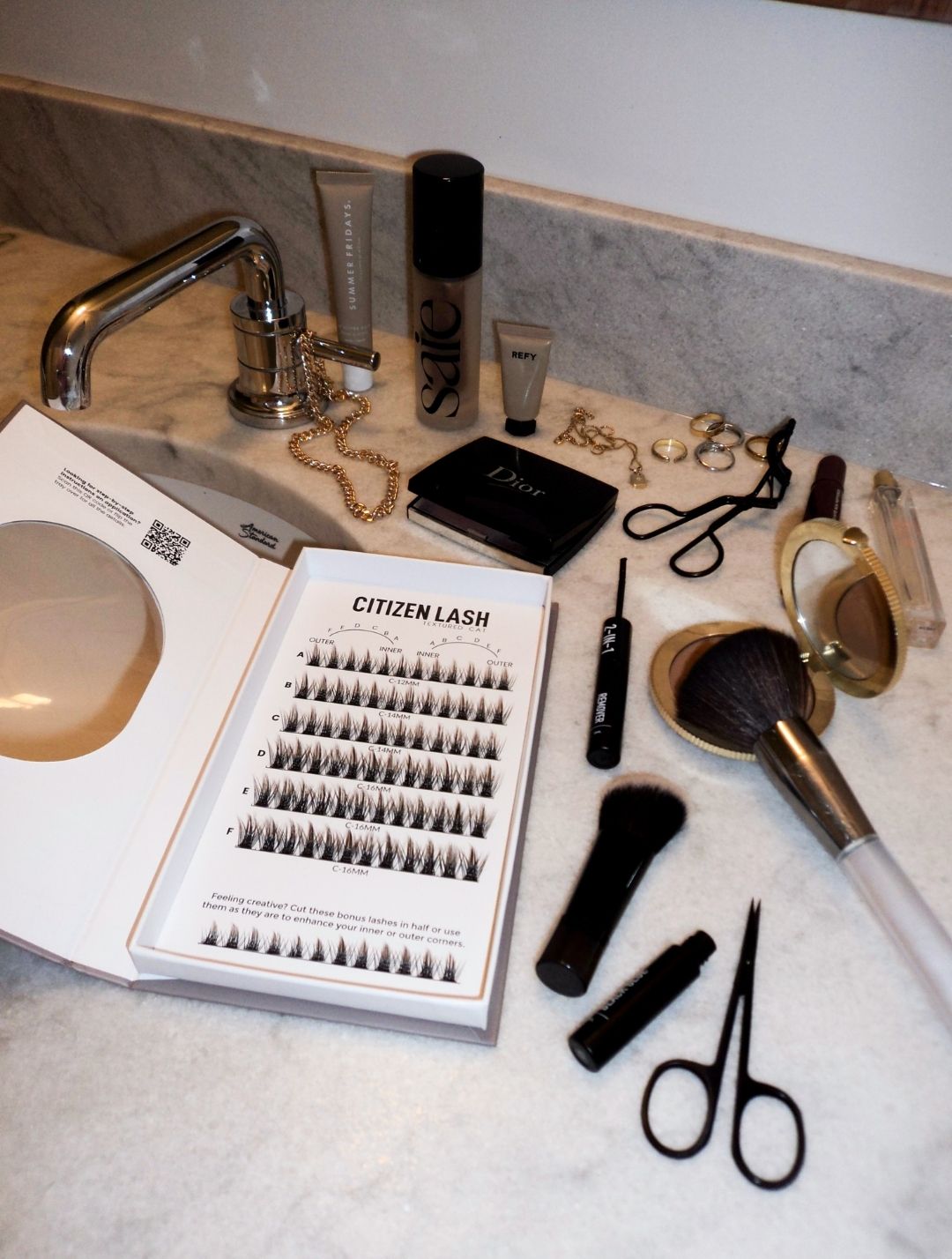 Eyelash extensions and related products on a bathroom counter.